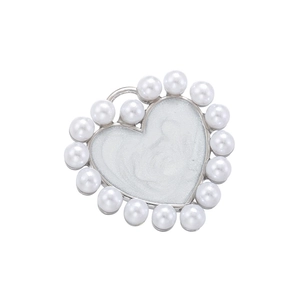 Detail shot of heart pendant with pearl border and white resin fill for DIY jewelry