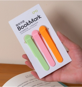 Three colorful silicone page-following bookmarks in green, pink, and orange packaging