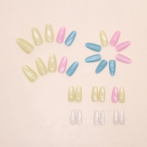 Detail of colorful cat-eye press-on nails with almond shape and pearlescent finish