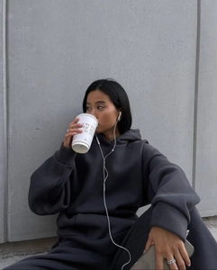 Deep grey oversized hoodie and high waist shorts set in a minimalist neutral setting