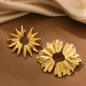 Detail of 18K gold-plated irregular floral and leaf earrings on leather and silk