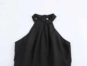 Detailed view of sleeveless halter neckline with pleated texture and back zipper closure