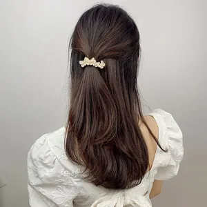 Detail of sweet butterfly rhinestone hair clip styled in a half-up ponytail for women