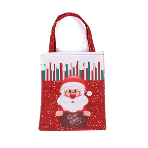 Red Christmas gift bag with Santa Claus print and Warm Wishes text in non-woven fabric