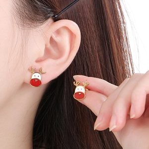 Detail of Christmas reindeer earrings featuring red and white enamel on a gold-plated base