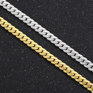 Polished gold and silver Cuban link chain necklaces for hip hop style on black surface