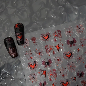 Gothic nail stickers featuring red glitter spiders and black web designs on grey background