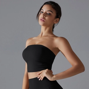 Detail view of black strapless yoga top with side pleats and matte high-stretch fabric