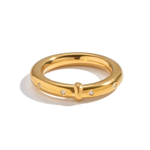 Détail de la bague en acier inoxydable doré avec strass et motif de boucle métallique