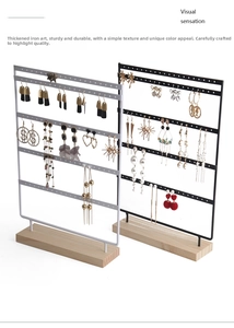 Detailed view of a 5-tier metal earring holder with a solid wooden base for jewelry display