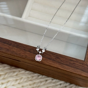 Macro shot of a pink square cut zircon pendant on a fine silver necklace chain