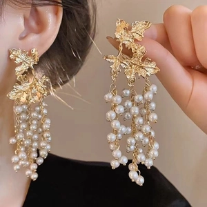 Vintage gold leaf drop earrings with white pearl tassels in a bohemian retro style
