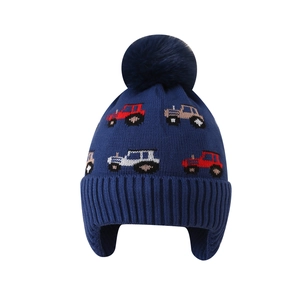 Kids navy blue knit trapper hat with tractor pattern and cozy faux fur pom-pom
