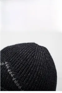 Close-up of thick ribbed knit texture on a winter warm thermal beanie with grey marl detail