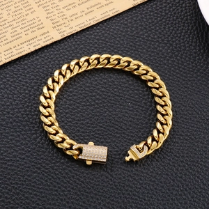 Detail of gold Cuban link bracelet with diamond buckle on vintage newspaper background