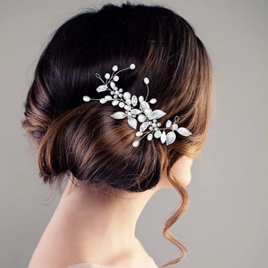 Silver bridal hair vine with white pearls and leaves on a model's elegant updo hair