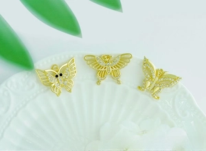 Detailed macro of 18K gold plated butterfly charms with micro-paved cubic zirconia stones