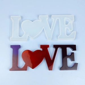 Macro shot of LOVE letter and heart silicone mold with gradient resin craft samples