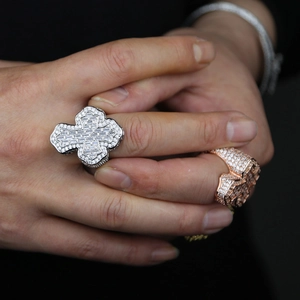 Close-up of hip hop style cross rings with dense zircon in silver and rose gold finish