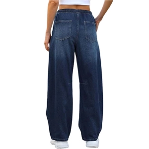 Detail view of the elastic high waist and back pockets of dark blue wide-leg denim jeans