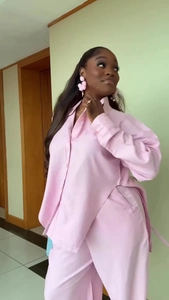 Detail view of pink notched lapel shirt with side slit and matching straight trousers set