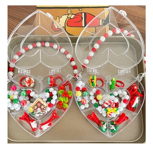 Detailed set of Christmas jewelry for kids including bracelets and rings in heart boxes
