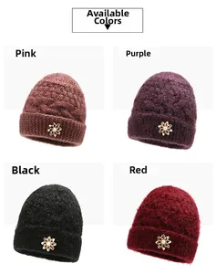 Detailed close-up of knit winter hats in four colors with pearl floral ornaments