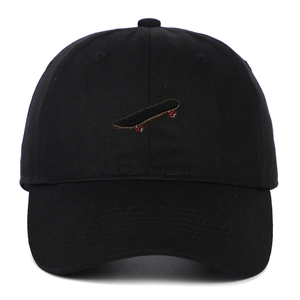Close-up of black cotton baseball cap with detailed skateboard embroidery on the front