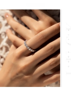Close-up of sparkling D-color moissanite eternity ring in S925 sterling silver on finger