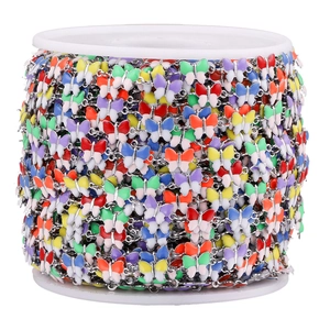 Detail of colorful enamel butterfly chain on a spool for DIY jewelry making