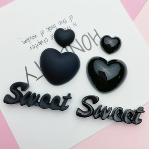 Detail showing matte and glossy heart charms with Sweet letter resin accessories
