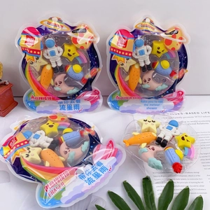 Detail of space-themed eraser set showing astronaut, rocket and planet shapes in packaging