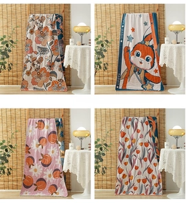 Detail view of 4-layer cotton gauze towels with floral, peach and rabbit patterns