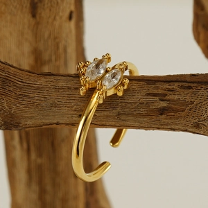 Polished gold christmas tree ring with marquise zircon stones on natural wood branch