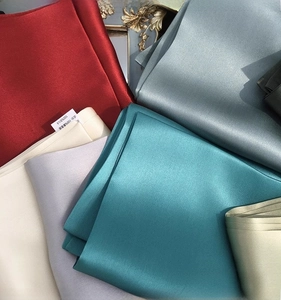 Detail showing 100% pure silk scarves with soft sheen and smooth satin texture