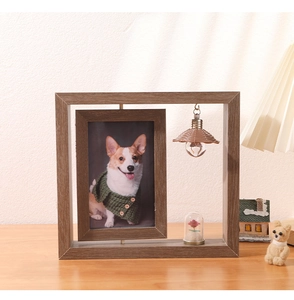 Close-up of rotating 6-inch wooden picture frame with preserved flower and miniature bulb