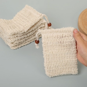 Detail of natural sisal soap foaming net bag with wooden bead drawstring closure