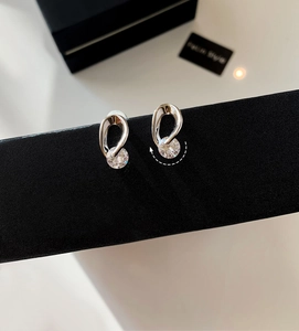 Detail of silver zirconia earrings showing the unique rotating circular dangle design
