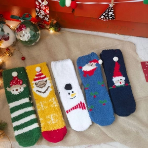Set of five warm coral fleece Christmas socks with festive cartoon dolls and 3D details
