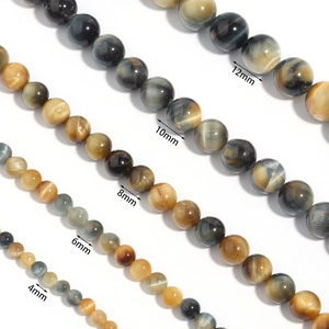 Comparison of tiger eye stone beads in different sizes from 4mm to 12mm on white background