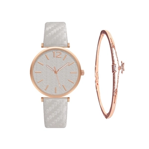 Close-up of women's quartz watch with embossed leaf dial and matching star bracelet