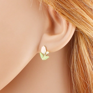 Elegant tulip stud earrings with white petals green leaves and a pearl on model
