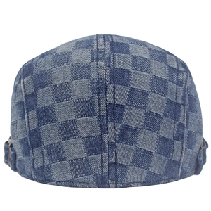 Close-up of checkered denim beret showing twill fabric texture and metal buckle