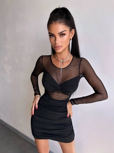Detail of sheer mesh patchwork on a sexy black long sleeve bodycon mini dress