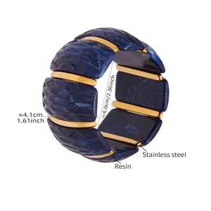 Detailed view of wide resin stretch bracelet with blue marble texture and steel spacers