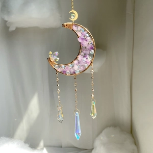Detail of moon-shaped suncatcher with purple amethyst stones and crystal prism pendants