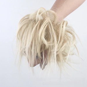 Detailed close-up of blonde messy hair bun scrunchie extension for voluminous hairstyles