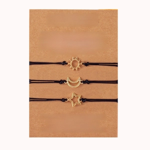 Three sun moon and star woven friendship bracelets on a gift card for sisters