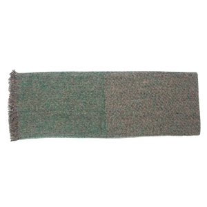Detail view of woven fabric texture with green and brown mixed yarns and tassel edges