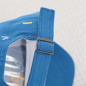 Close-up showing the adjustable metal buckle and fabric texture of the blue toddler baseball cap